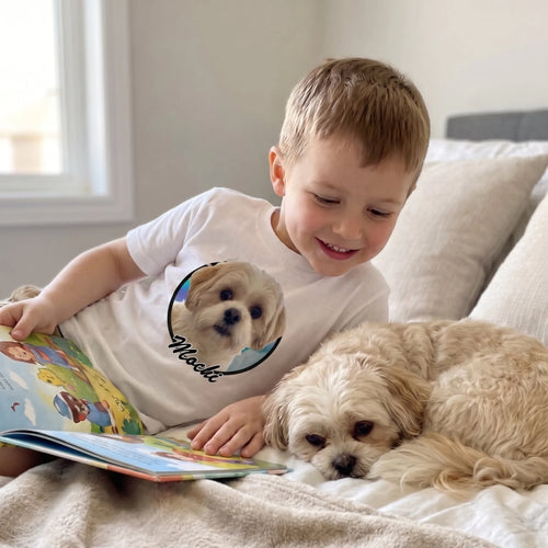 Boy reading on his bed in a white kids' custom pet photo t-shirt with his Shih Tzu