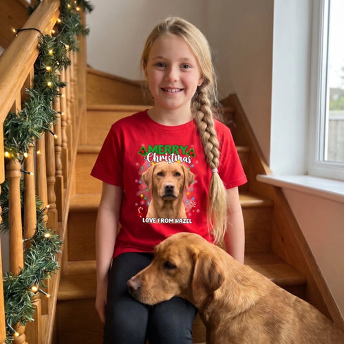 Girl on the stairs on Christmas Eve in a red kids' personalised Christmas lights pet t-shirt with her Labrador
