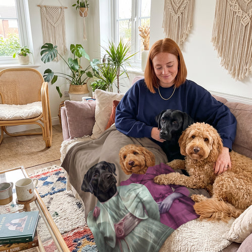 Black Labrador and goldendoodle with The Sisters custom pet blanket: owner + pet on sofa